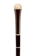 An antique walking stick with ivory top and decoration on a snakewood shaft with&nbsp;brass ferrule, 19th century, 95cm high
