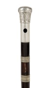 An antique musical walking stick with silver top, ebony flute shaft and brass ferrule, 19th century, 96cm high