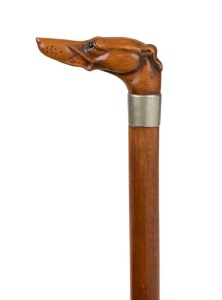 An antique walking stick with carved boxwood dog's head handle, silver plated collar, Malacca cane shaft and brass ferrule, 19th century, 89cm high