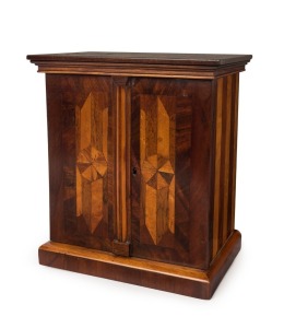 A beautiful antique English marquetry sewing companion cabinet, with two doors opening to reveal an impressive arrangement of drawers and compartments, handsomely inlaid in geometric designs in mahogany, maple, rosewood, sycamore and others, 19th century, 31cm high, 27cm wide, 18cm deep