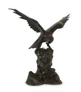 An antique Japanese cast bronze eagle sculpture, Meiji period, 19th century, seal mark to the rear near base, 64cm high, 60cm wide, 33cm deep