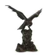 An antique Japanese cast bronze eagle sculpture, Meiji period, 19th century, seal mark to the rear near base, 64cm high, 60cm wide, 33cm deep