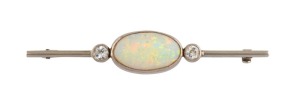 An Australian Art Deco 18ct white gold brooch, set with a stunning solid white opal, flanked by two brilliant cut white diamonds, early to mid 20th century, ​​​​​​​maker's marks rubbed, 5.9cm wide, 4.6 grams total