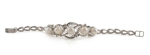 An impressive 18ct white gold bracelet, set with five pearls, surrounded by brilliant cut white diamonds, mid 20th century, stamped "18ct", ​​​​​​​15cm long, 14.5 grams total