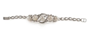 An impressive 18ct white gold bracelet, set with five pearls, surrounded by brilliant cut white diamonds, mid 20th century, stamped "18ct", 15cm long, 14.5 grams total