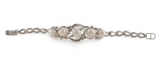 An impressive 18ct white gold bracelet, set with five pearls, surrounded by brilliant cut white diamonds, mid 20th century, stamped "18ct", ​​​​​​​15cm long, 14.5 grams total