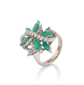 A 14ct white gold cocktail ring, set with seven almond shaped emeralds and assorted white diamonds, 6.9 grams total