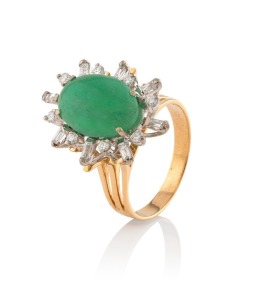 An 18ct yellow gold ring, set with a polished jade surrounded by diamonds, stamped "18ct", 6.8 grams