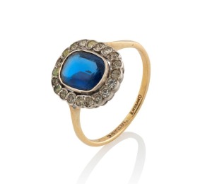 An antique English yellow gold ring, set with a fine cabochon Ceylonese sapphire, surrounded by diamonds, 19th century, 2.3 grams