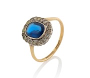 An antique English yellow gold ring, set with a fine cabochon Ceylonese sapphire, surrounded by diamonds, 19th century, ​​​​​​​2.3 grams&nbsp;