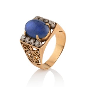 A vintage gold and star sapphire ring flanked by two rows of white diamonds, 20th century, 6 grams