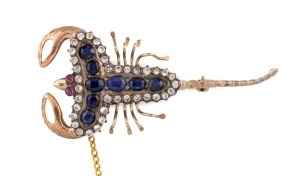 An antique scorpion brooch, 9ct yellow gold, set with ruby eyes, amethysts and white stones, late 19th century, 6cm long, 9.6 grams