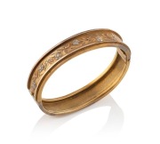 An antique yellow gold bangle decorated with applied silver flowers, 19th century, 6cm wide (internal 5.5cm wide), 16 grams