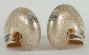 A fine pair of carved and engraved nautilus shells titled "NOUMEA, New Caledonia", the larger 12cm high, 15cm wide - 2