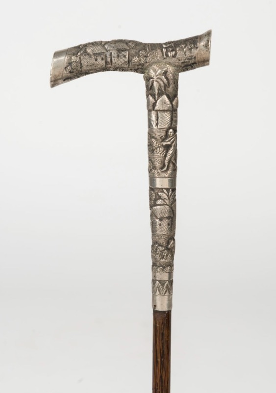 An antique walking stick with Indian silver handle, palm wood shaft and remains of metal ferrule, 19th century, ​​​​​​89.5cm high