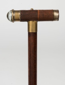 A vintage walking stick with torch handle covered with lizard skin, on a timber shaft with brass ferrule, 20th century, 82.5cm high