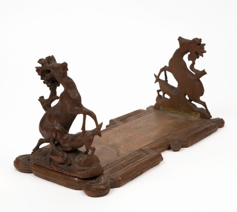 An antique Black Forest adjustable bookstand with hunting scene ends, 19th century, ​​​​​​​16cm high, 34cm wide when closed