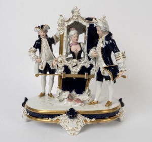 ROYAL DUX Czechoslovakian porcelain figural group of a lady in sedan with footmen, 20th century, triangle factory mark to base, 39cm high