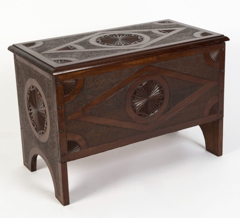 An Australian maple lift-top trunk with diamond motif panels and chip-carved roundels and shells, circa 1910, 49cm high, 71.5cm wide, 39cm deep