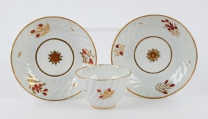 WORCESTER antique English porcelain tea ware, comprising a tea bowl and two saucers with gilt and floral decoration, circa 1820, (3 items), the tea bowl 6cm high