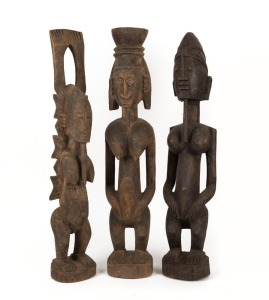 Three tribal statues, carved wood, West African origin, the largest 71cm high