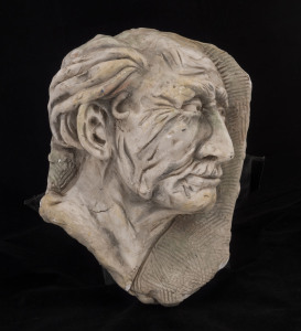 A plaster relief bust portrait in profile, 20th century, 33cm high, 23cm wide