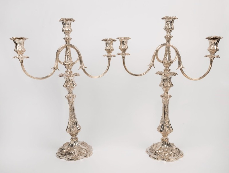 An impressive pair of antique three branch Sheffield plated candelabra, 19th century, 59.5cm high, 45cm wide each