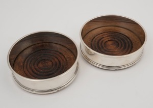 A pair of English sterling silver bottle coasters, made in London, mid 20th century, 4cm high, 13.5cm diameter