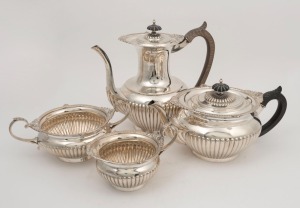 An antique four piece English sterling silver tea service by Walker & Hall of Sheffield, circa 1902, 22cm high, 1955 grams total (including handles)