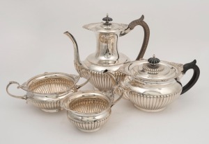 An antique four piece English sterling silver tea service by Walker & Hall of Sheffield, circa 1902, ​​​​​​​22cm high, 1955 grams total (including handles)