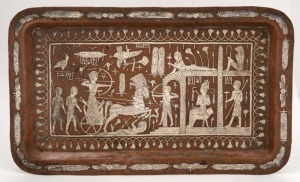 An antique Egyptian copper serving tray profusely inlaid with silver depicting Pharaonic scenes, 19th century, 40cm wide