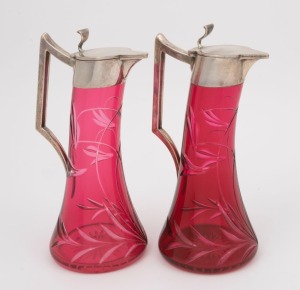 A pair of antique German silver and cut ruby glass schnapps decanters, 19th century, stamped "800" with crown and crescent mark, ​​​​​​​20cm high