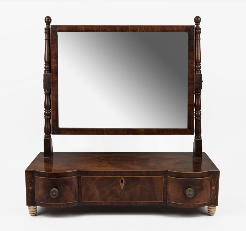 A Georgian mahogany toilet mirror with three drawers and turned whalebone beehive bun feet, early 19th century, ​​​​​​​55cm high, 53cm wide, 24cm deep