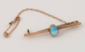 An antique Australian 9ct rose gold bar brooch, set with a solid polished opal, late 19th century, ​​​​​​​4.5cm wide, 3.9 grams total