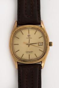 OMEGA "SEAMASTER" wristwatch in rolled gold and stainless steel case with gold dial, date window, baton numerals and brown leather band, circa 1970. 3.8cm wide including crown