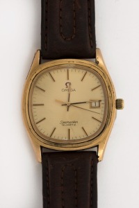 OMEGA "SEAMASTER" wristwatch in rolled gold and stainless steel case with gold dial, date window, baton numerals and brown leather band, circa 1970. 3.8cm wide including crown