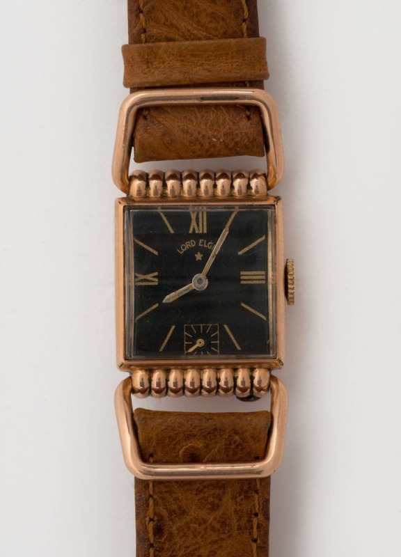 LORD ELGIN manual wristwatch in rectangular rolled gold and stainless steel case, black face, subsidiary second dial and brown leather band. 2.7cm wide including crown