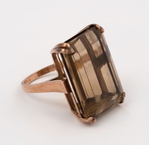 A 9ct rose gold ring, set with a large emerald cut smoky quartz specimen, 14 grams total