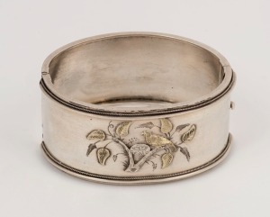 An antique silver bangle decorated with a nesting bird in a branch finished in gold, most likely Australian, 19th century, 6.5cm wide (internal 5.7cm), 36 grams