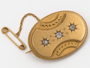 An antique 18ct yellow gold oval brooch, set with three diamonds, circa 1870, reverse fitted with mourning window, and housed in original box, ​​​​​​​4cm wide, 13.6 grams total