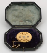 An antique 18ct yellow gold oval brooch, set with three diamonds, circa 1870, reverse fitted with mourning window, and housed in original box, ​​​​​​​4cm wide, 13.6 grams total - 2