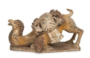 A Chinese pottery camel statue with remains of polychrome finish, modeled in unusual pose, Tang Dynasty (618 to 907 A.D.). With accompanying&nbsp;thermoluminescence test certificate from Oxford Authentication Ltd, United Kingdom (HK 2123-691). 18cm high, 35cm 