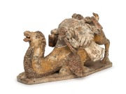 A Chinese pottery camel statue with remains of polychrome finish, modeled in unusual pose, Tang Dynasty (618 to 907 A.D.). With accompanying&nbsp;thermoluminescence test certificate from Oxford Authentication Ltd, United Kingdom (HK 2123-691). 18cm high, 35cm - 2