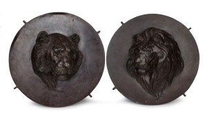 A pair of Japanese antique bronze circular plaques adorned with tiger and lion heads, Meiji period, 19th/20th century, 37cm diameter