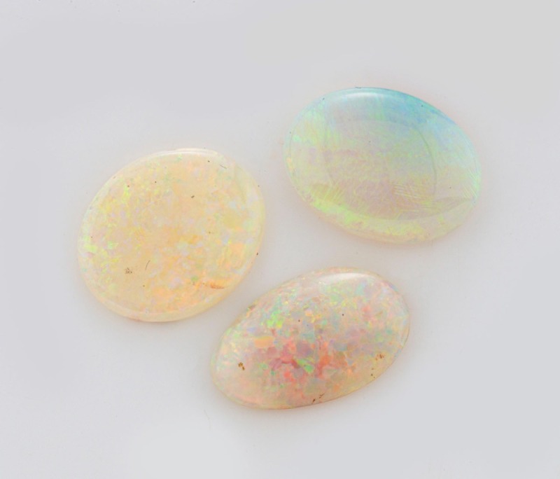 OPALS. Three Lightning Ridge solid white opals, ​​​​​​​the largest 1.6cm long