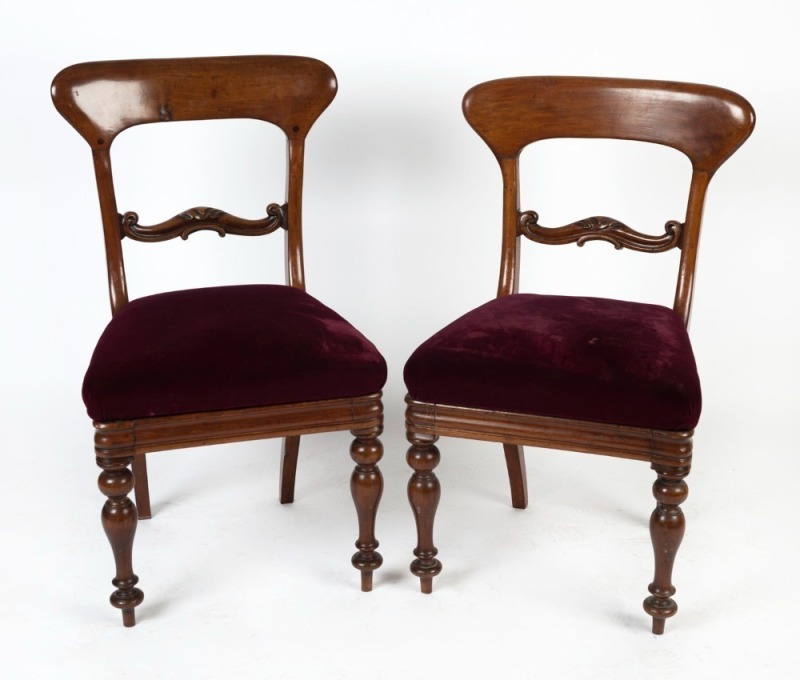 A pair of antique English spade back mahogany dining chairs with purple upholstery, 19th century