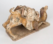 A Chinese pottery camel statue with remains of polychrome finish, modeled in unusual pose, Tang Dynasty (618 to 907 A.D.). With accompanying&nbsp;thermoluminescence test certificate from Oxford Authentication Ltd, United Kingdom (HK 2123-691). 18cm high, 35cm - 4