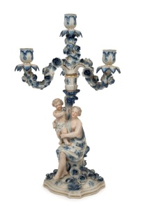 An antique German blue and white porcelain candelabra with figural base, 19th century, blue factory mark to base, 47cm high