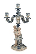 An antique German blue and white porcelain candelabra with figural base, 19th century,&nbsp; blue factory mark to base, ​​​​​​​47cm high