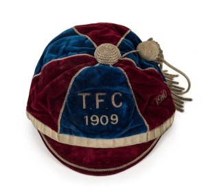 A sectioned maroon and navy blue honour cap dated 1909 and 1910, with metallic thread tassel, created for the "T.F.C." by "David Jones Ltd., Cap Makers, Sydney" with their label attached and endorsed "P. Ferguson" in pen. Superb condition. Research needed